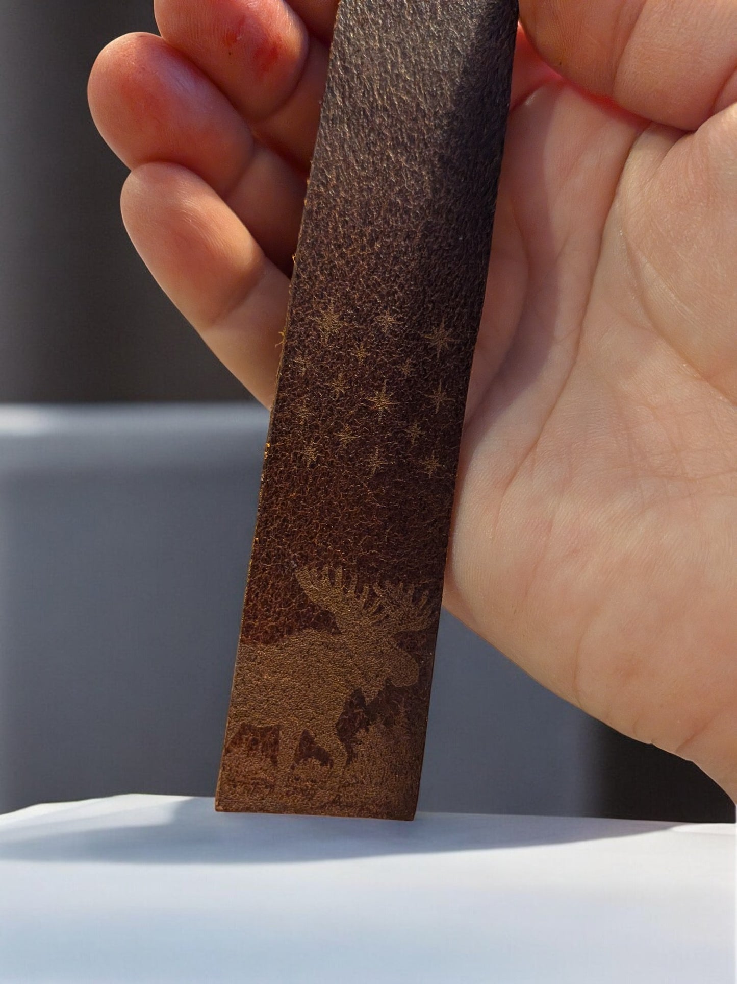 Leather bookmark with subtle engraved moose design