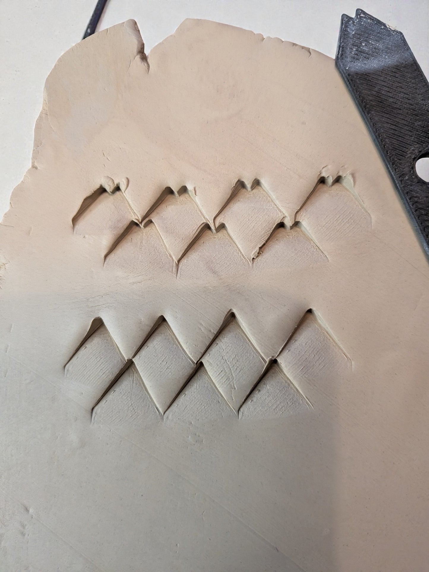 Kaksipäinen savitekstuurityökalu – vinoruutu ja käpykuvio